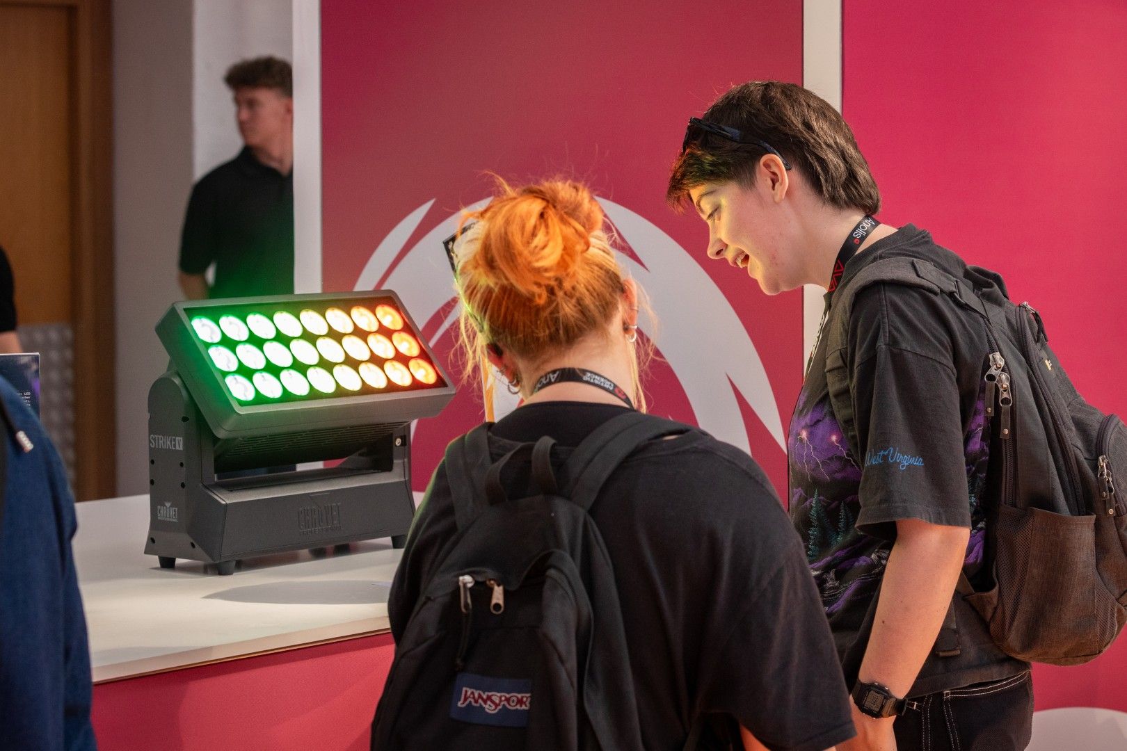 Two young visitors examine a Chauvet Professional Strike 1 lighting fixture on display in the Innovation Gallery at PLASA Show London 2025.