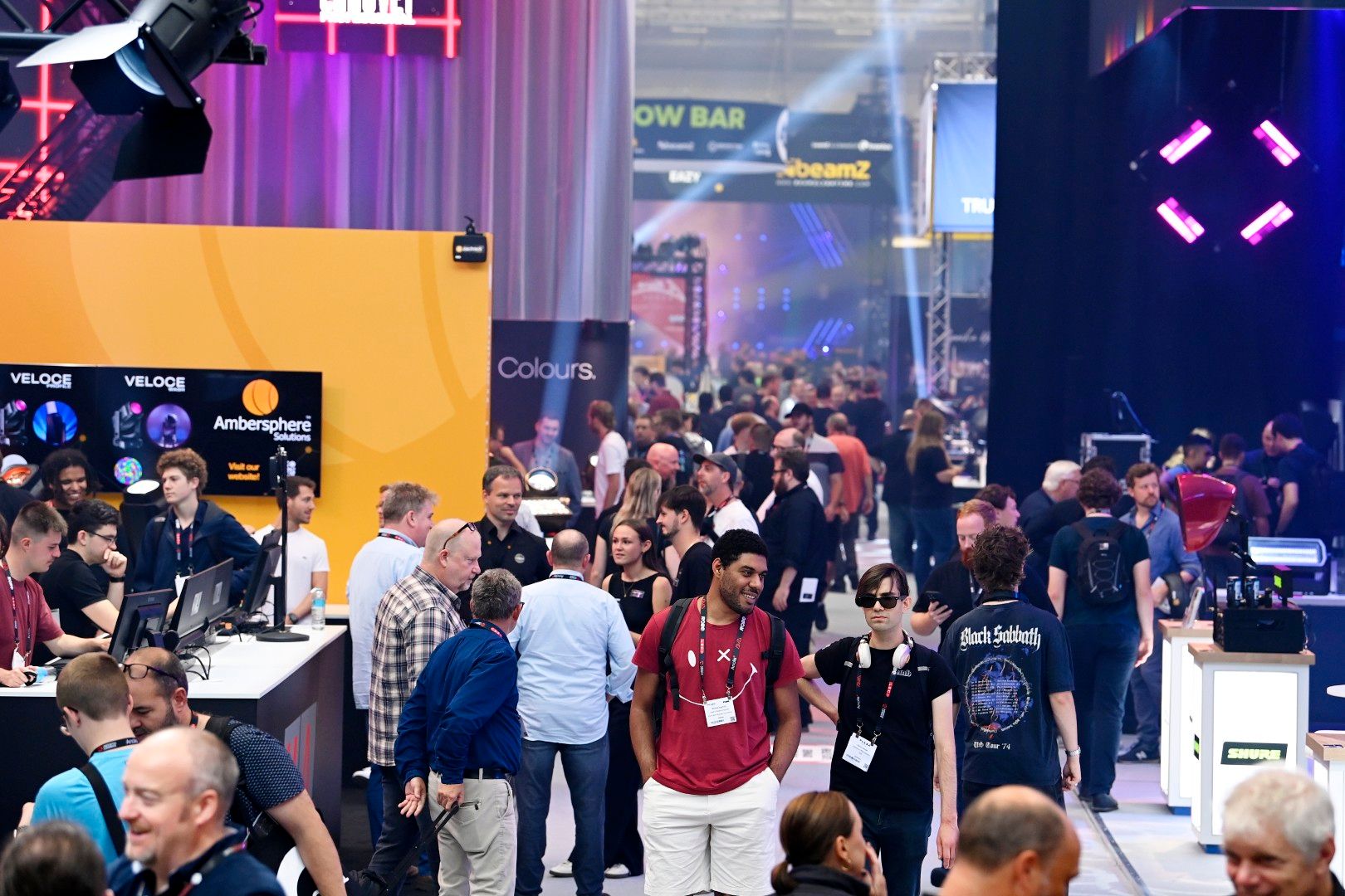 two male visitors walking through show floor at plasa show 2025