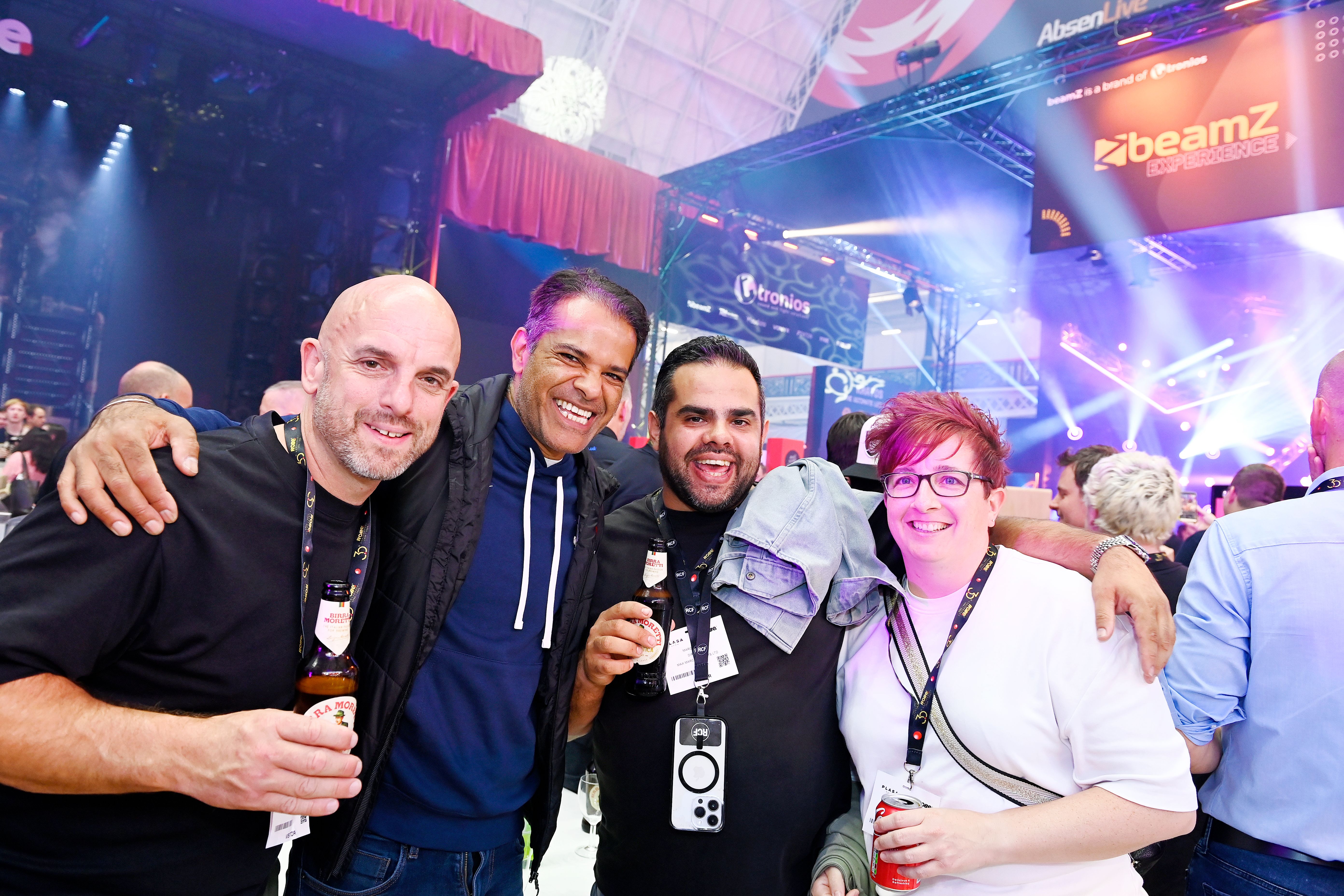 4 people posing for a picture at plasa show party