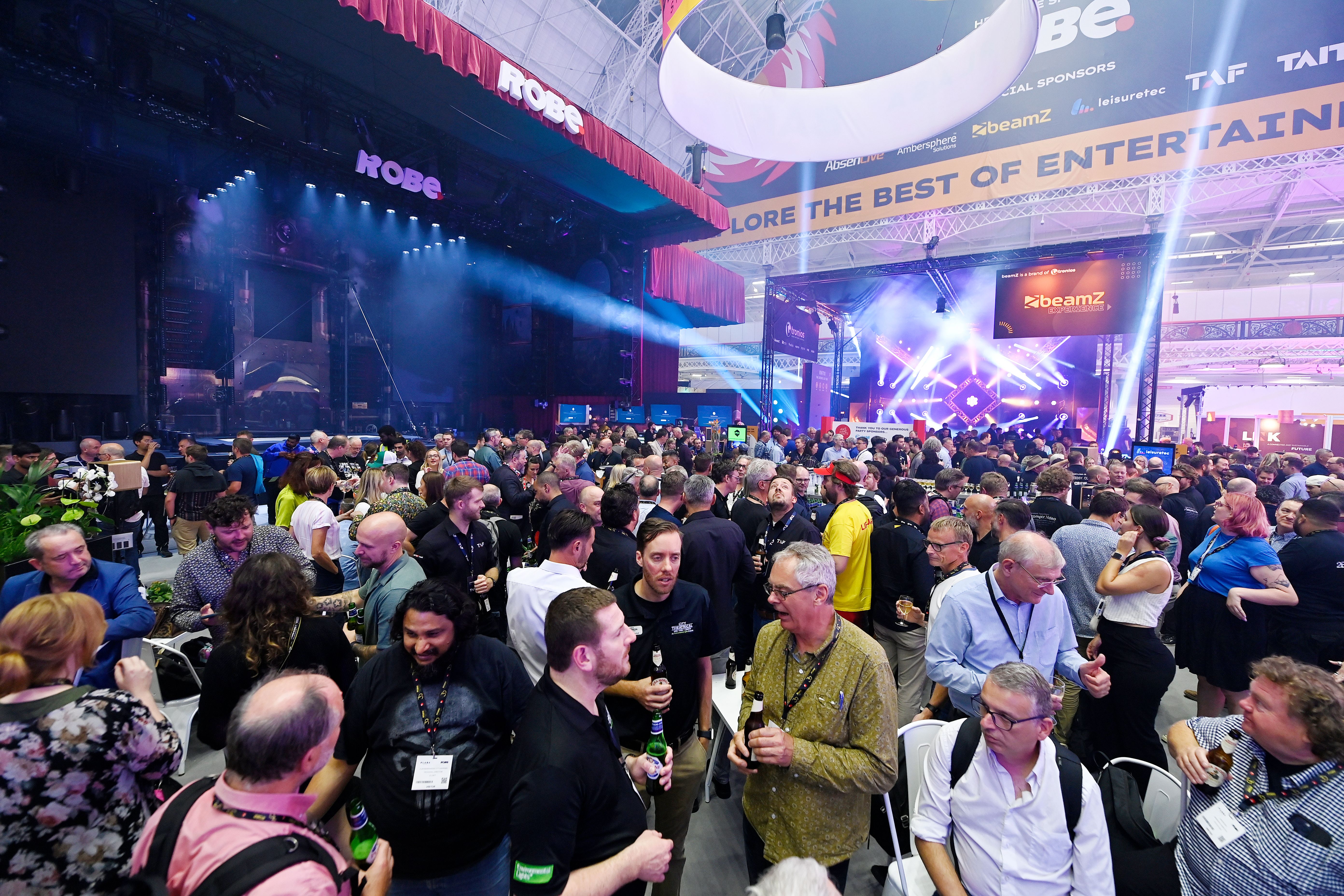 ariel view of a large group of people interacting at pasa show party