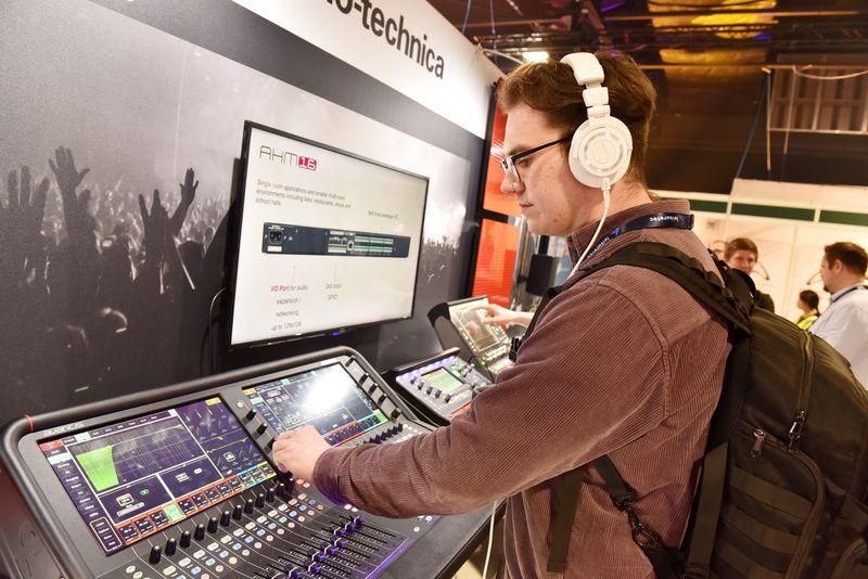 Visitor interacting with audio desk at PLASA Leeds 2023