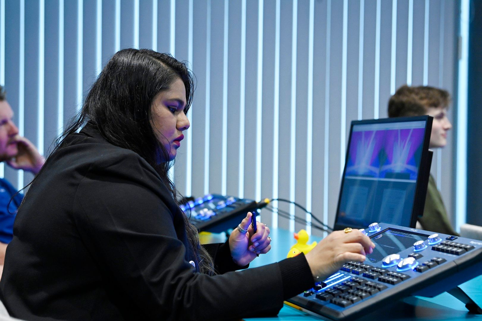 Female visitor using chamsys light desk at PLASA Focus Leeds 2024