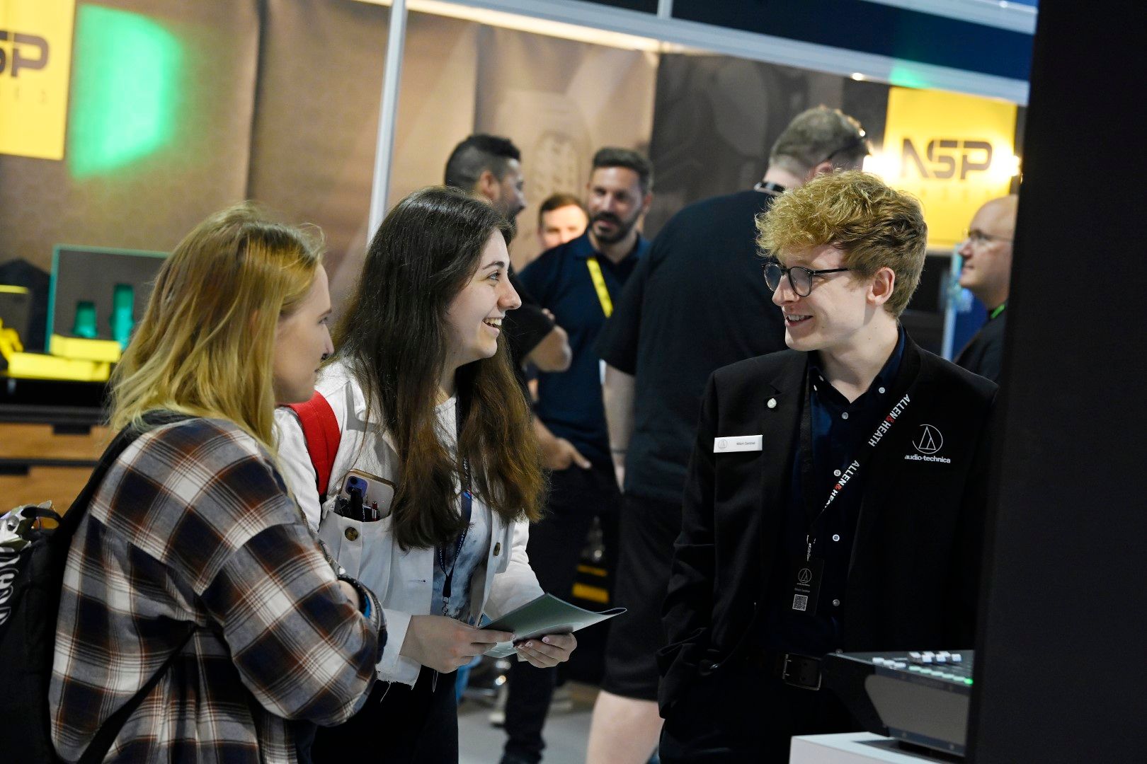 Students talking to an audio technica exhibitor at PLASA Focus Leeds