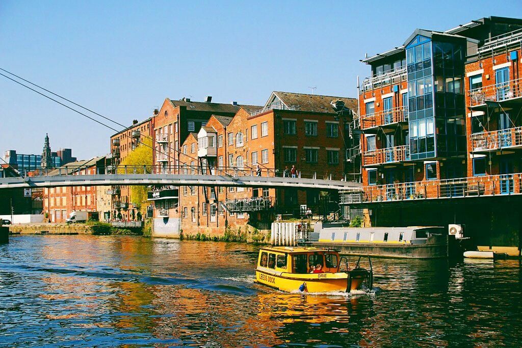 Water taxi crossing the river Aire in Leeds, UK