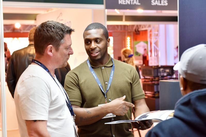 Aaron B exhibitor talking to visitor at plasa focus leeds trade show