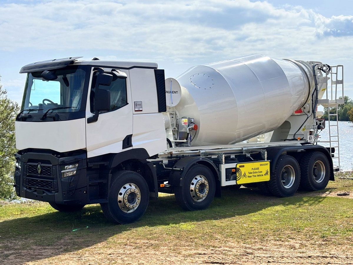 The Nugent M900 truck mixer with 9 m³ Hardox 450 drum, shown on-site with driver-access ladder and modular subframe.