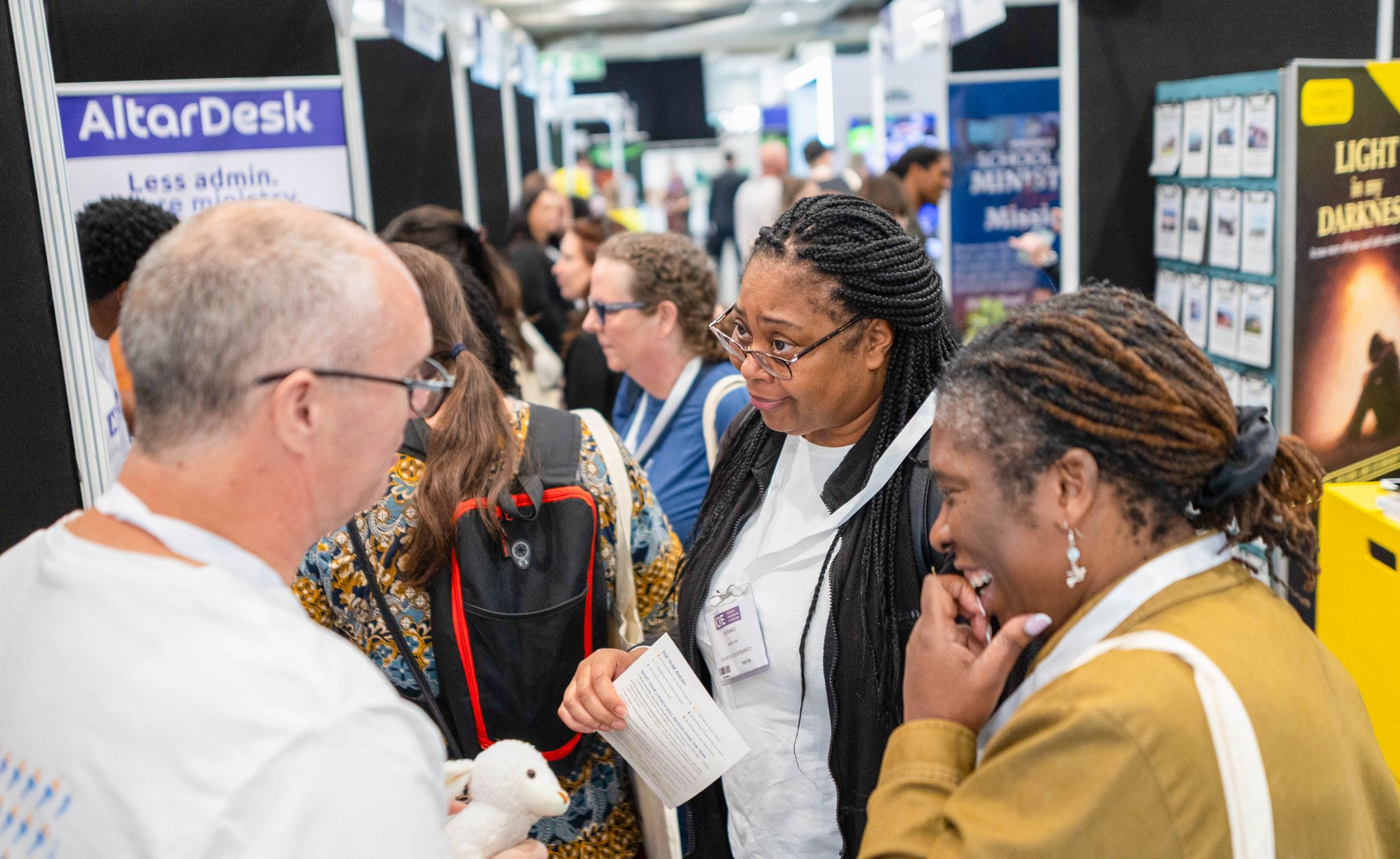 Visitors talking to exhibitor
