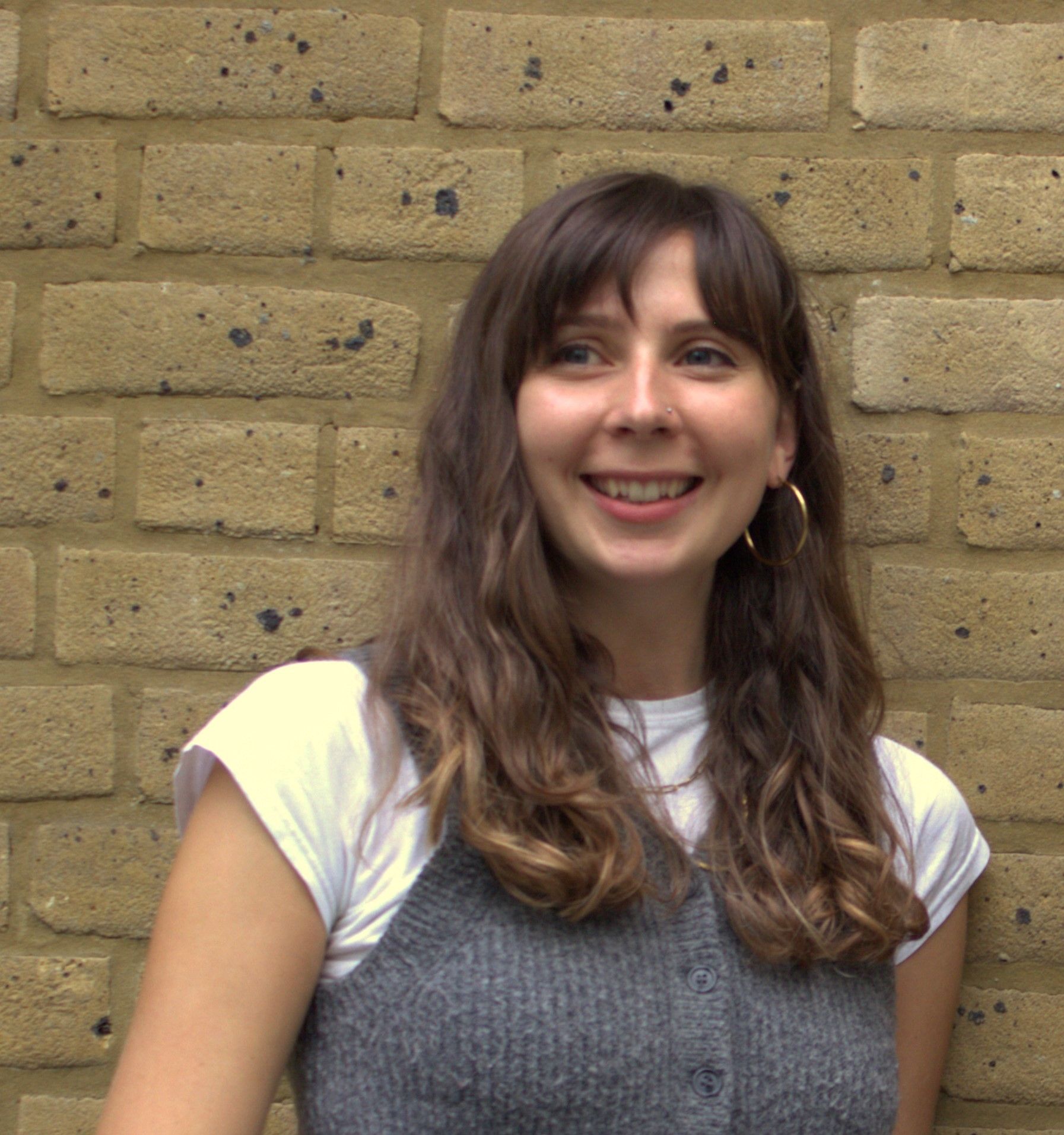 lady earring grey jumper smiling 