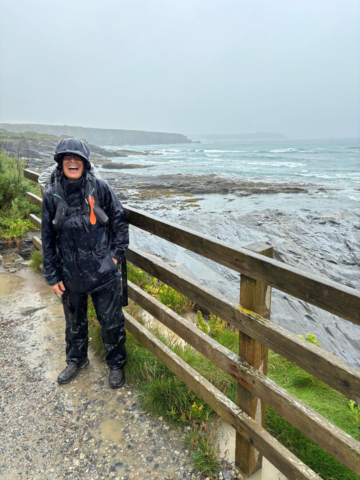 ladt in waterproof clothing on a coastal path