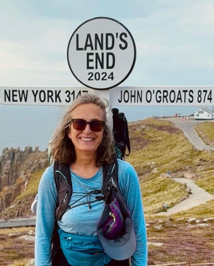 Lady standing in front of land's end sign