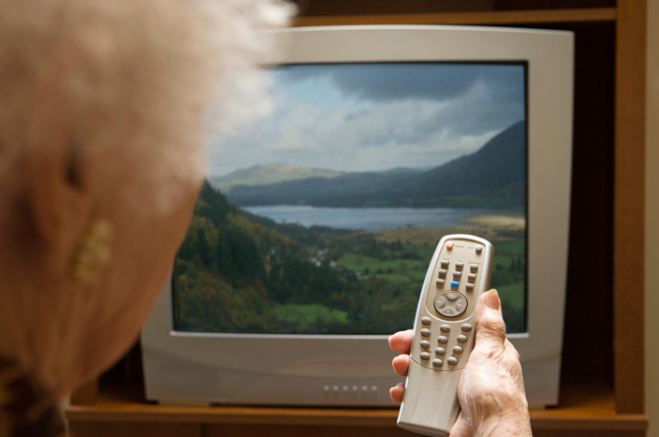 a woman with a tv remote