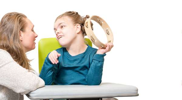 Child playing the tambourine.