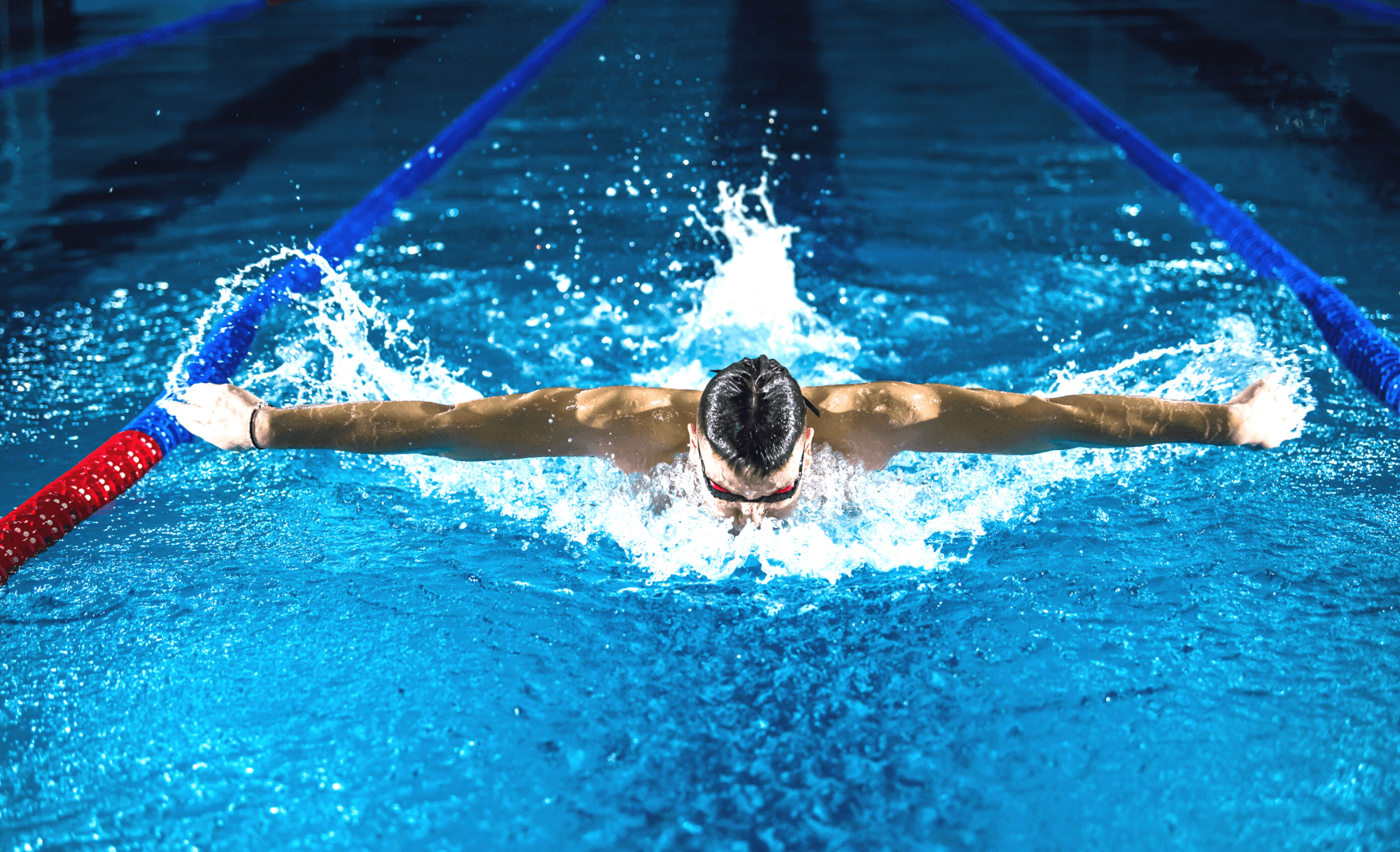 Picture of a man swimming in a swimming pool.