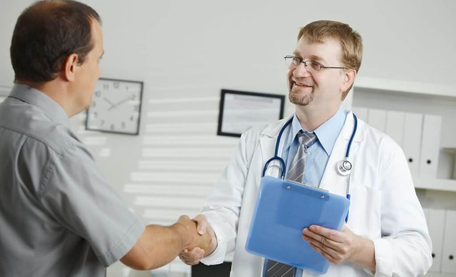 Picture of a doctor giving a patient a handshake.