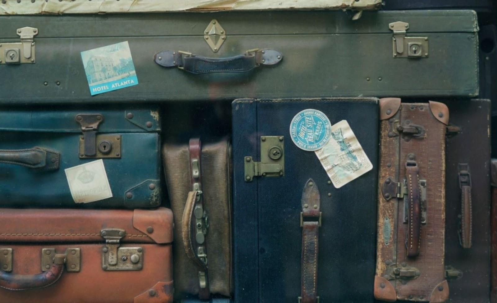 Picture of a range of different old suitcases.