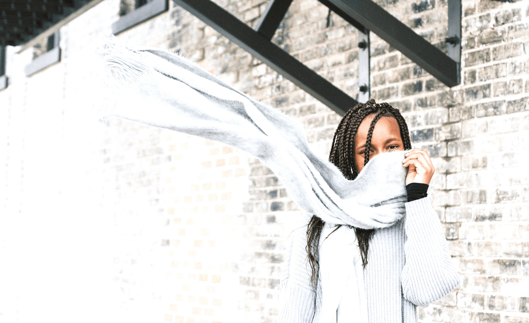 Picture of a young woman with a scarf wrapped around her neck.