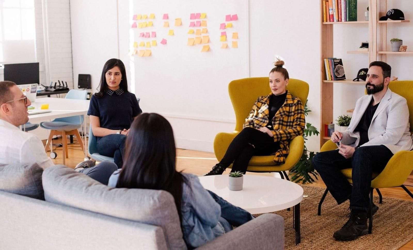 Picture of 5 people sat down having a conversation