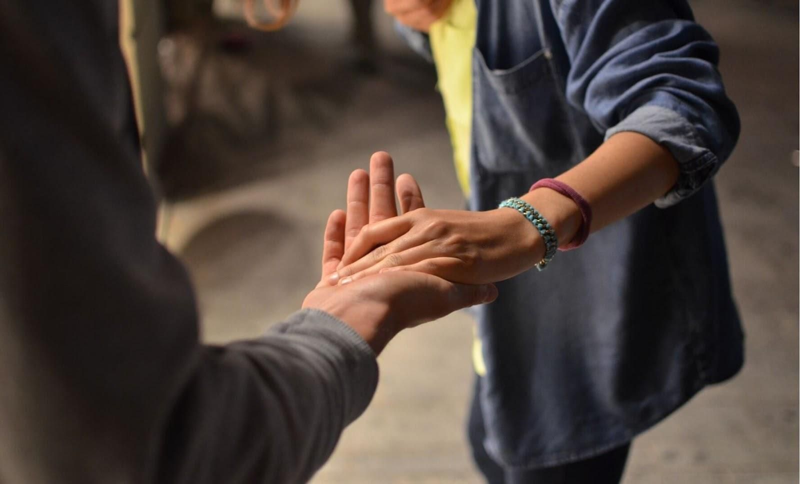 Picture of two people holding hands