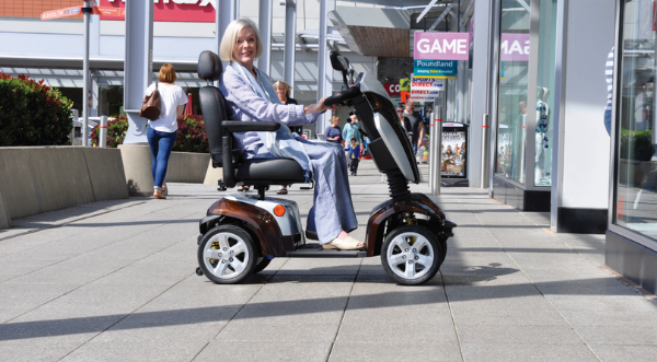 Picture of a woman using an electric scooter.