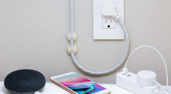 Picture of a smart plug charging a phone.
