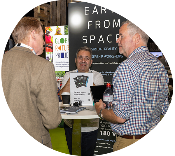 Exhibitor from Earth From Space speaking with prospects at their exhibition pod at Reset Connect London 