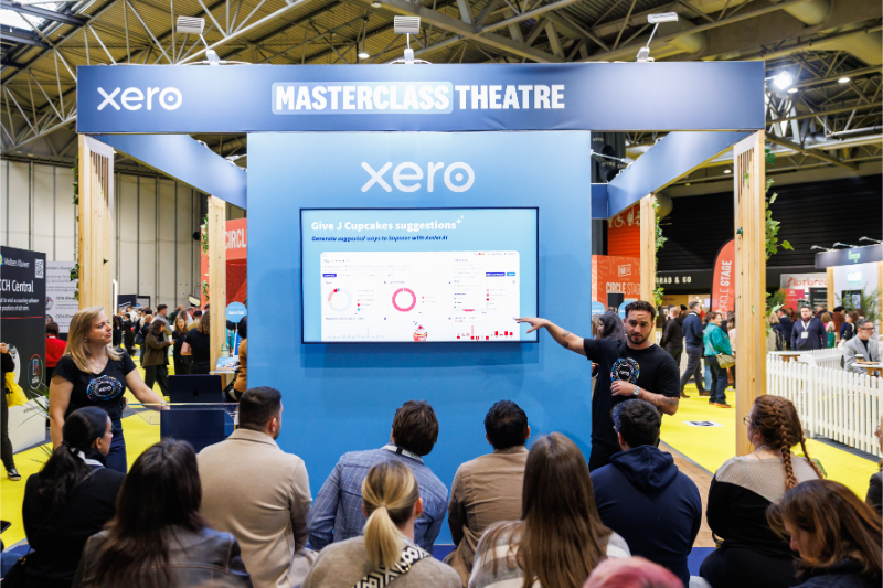 A presentation taking place at the Xero Masterclass Theatre, with an audience engaged in the discussion.