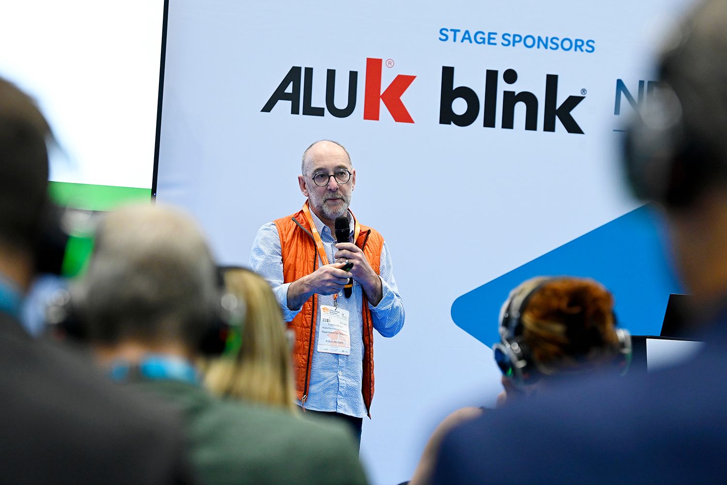 Sponsored stage area at Education Estates® Conference and Exhibition with seated audience