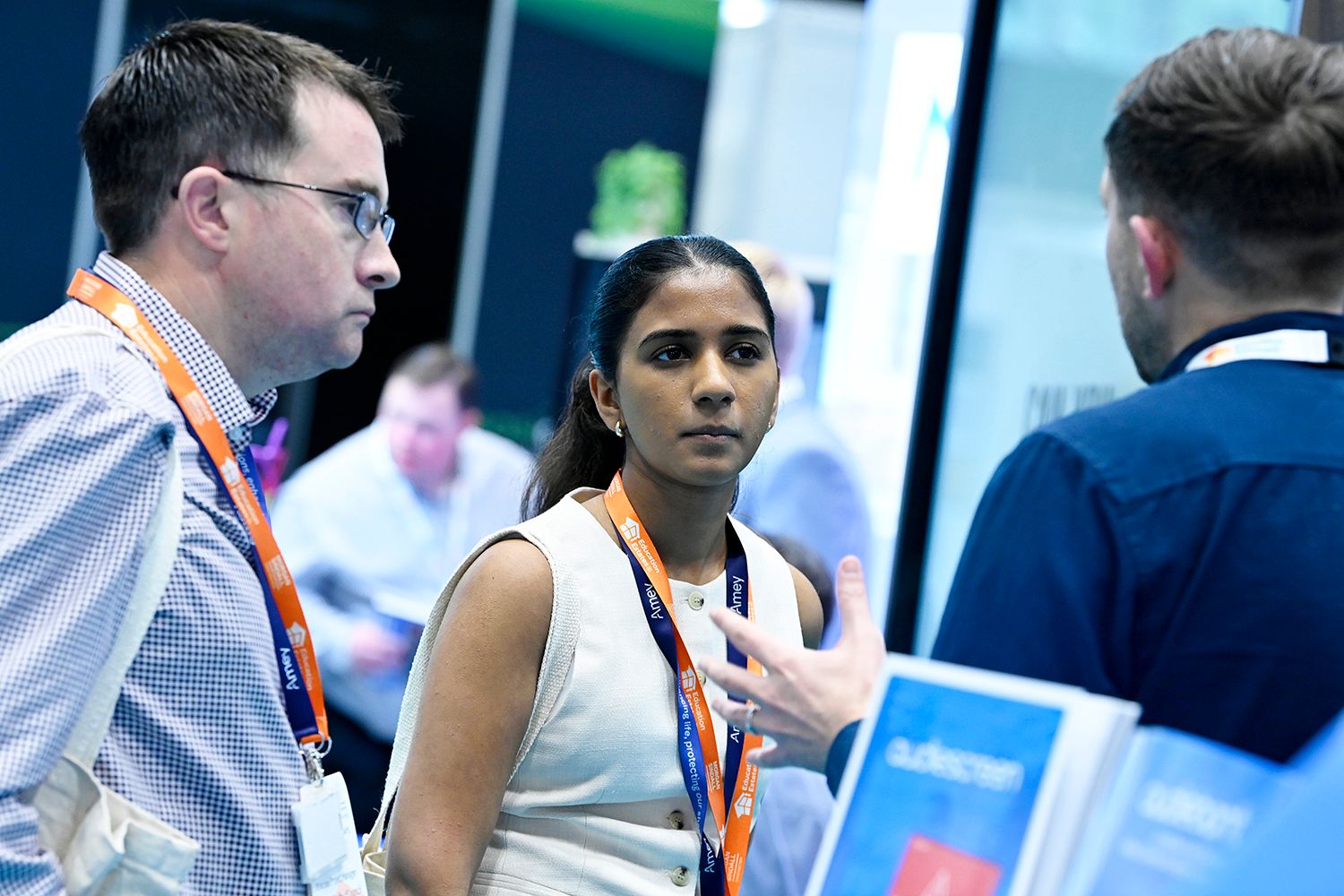 Education Estates® delegates networking while wearing branded lanyards