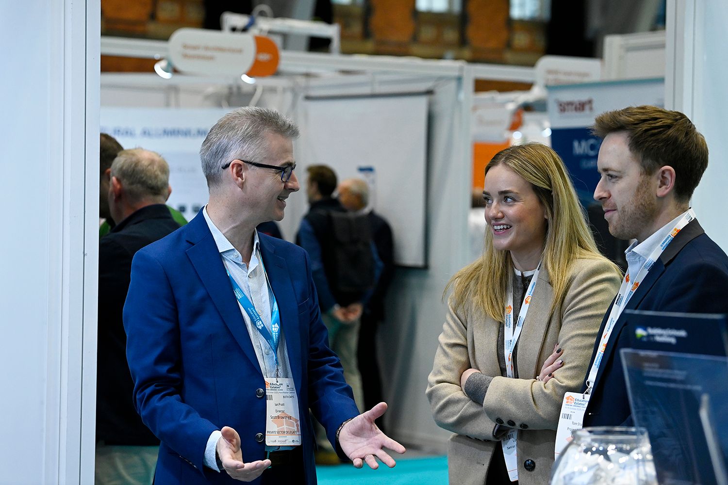 Education Estates® delegates networking while wearing branded delegate badges