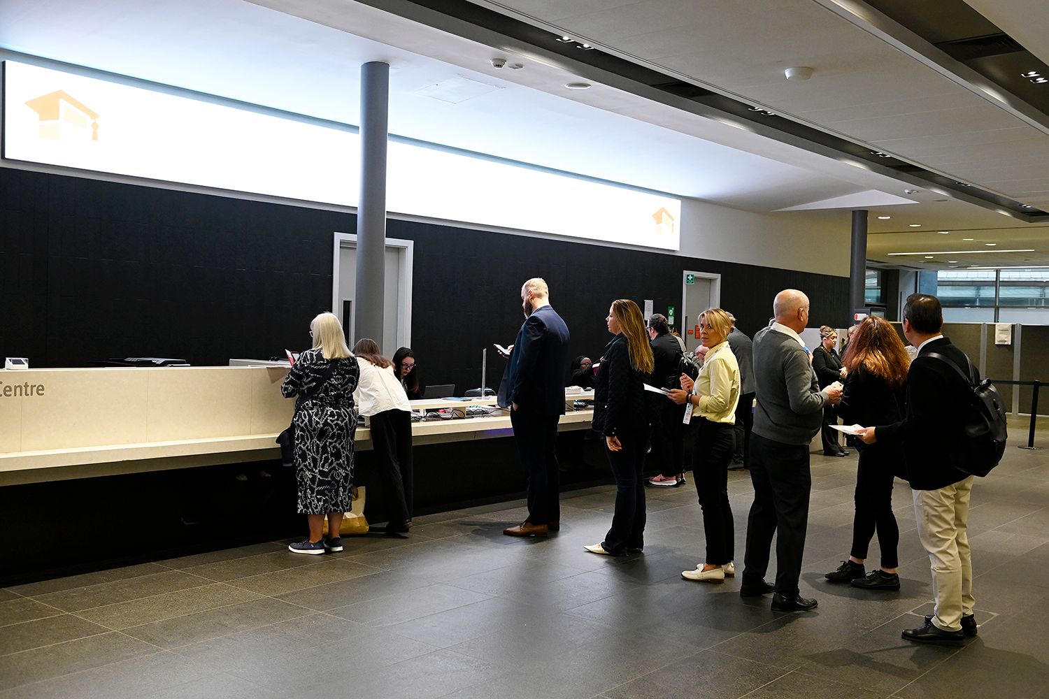 Delegates collecting their badges and lanyards for Education Estates® at the Welcome Desk in Manchester Central