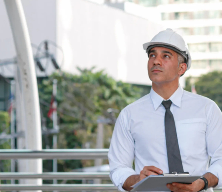 Educational leader working at a laptop, representing senior leadership attending Education Estates®