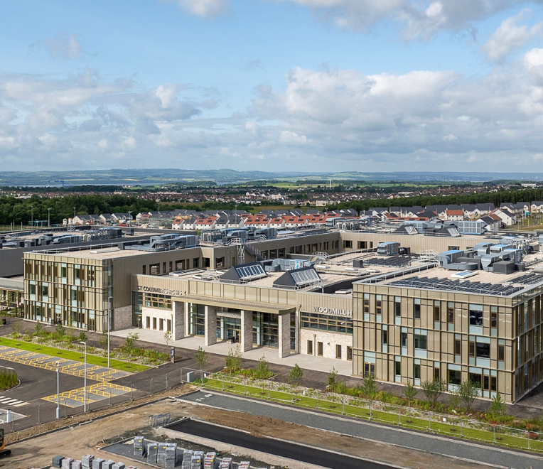 Educational leader working at a laptop, representing senior leadership attending Education Estates®