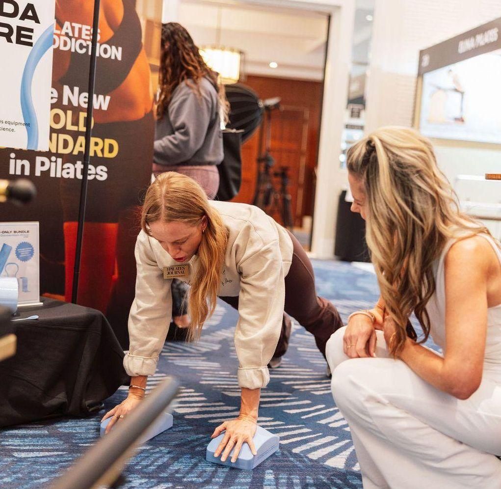Pilates instructor trying product at The Pilates Journal Expo