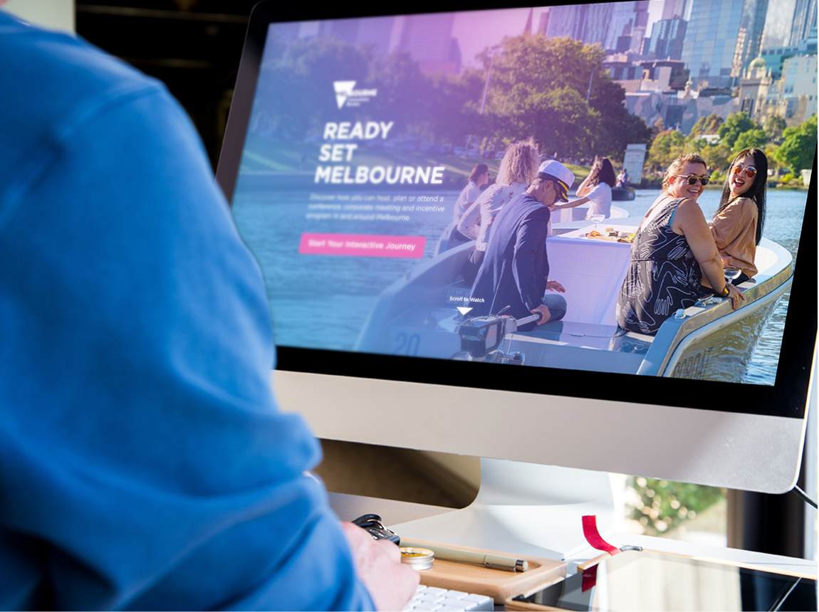 Person browsing The Melbourne Convention Bureau website on an iMac