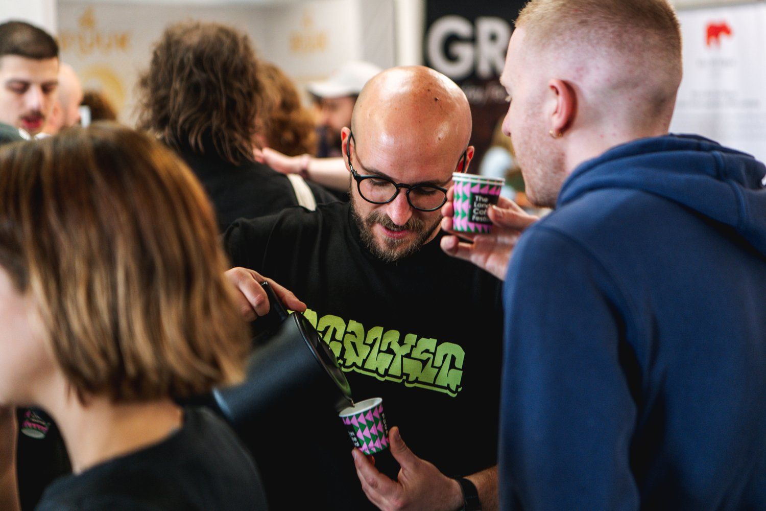 Visitors talking over coffee at The London Coffee Festival