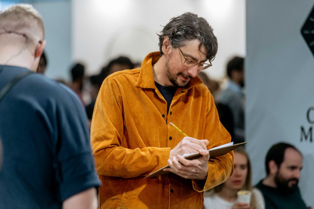 Man writing down in his note book
