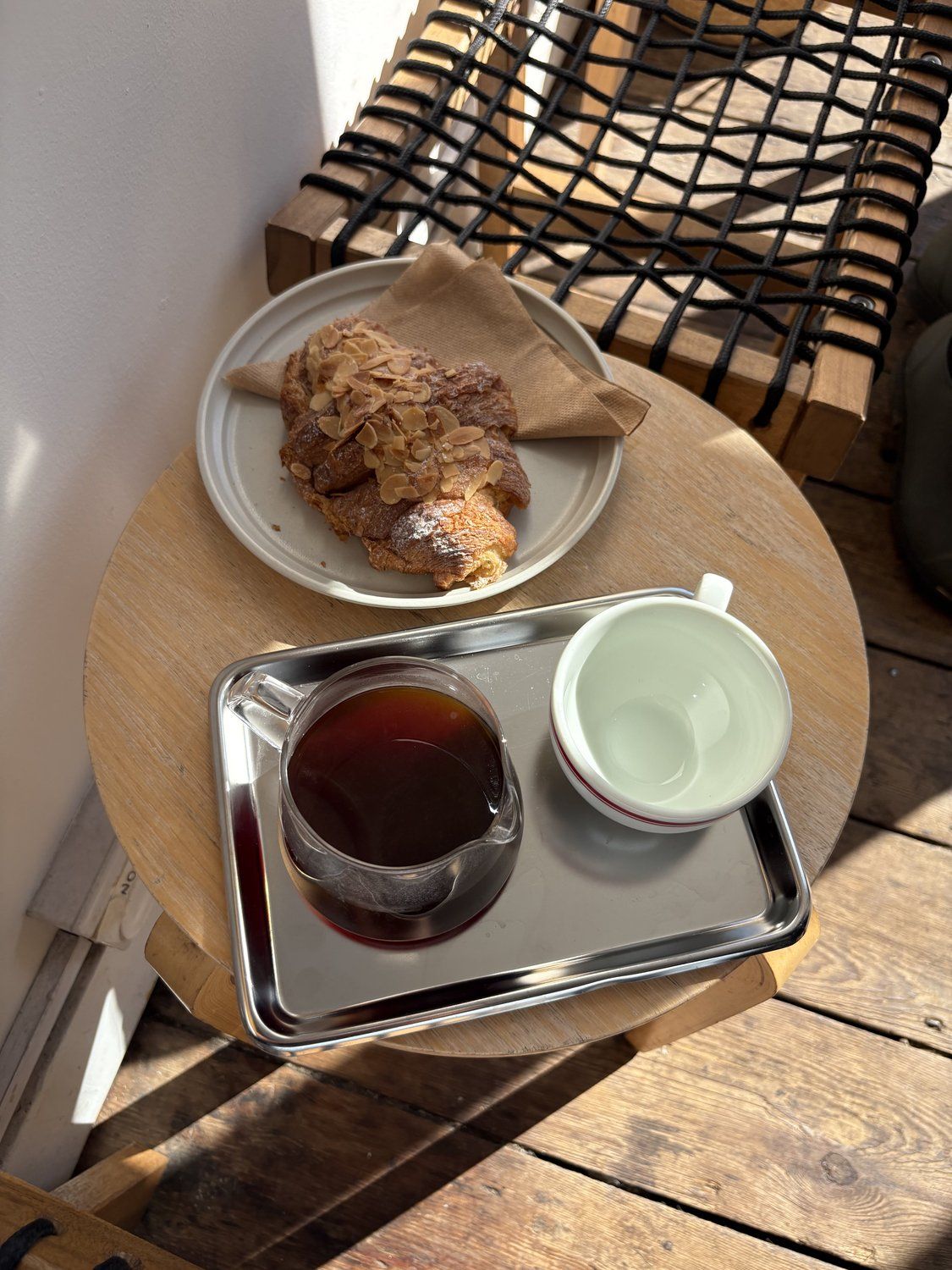 Filter coffee served with an almond croissant