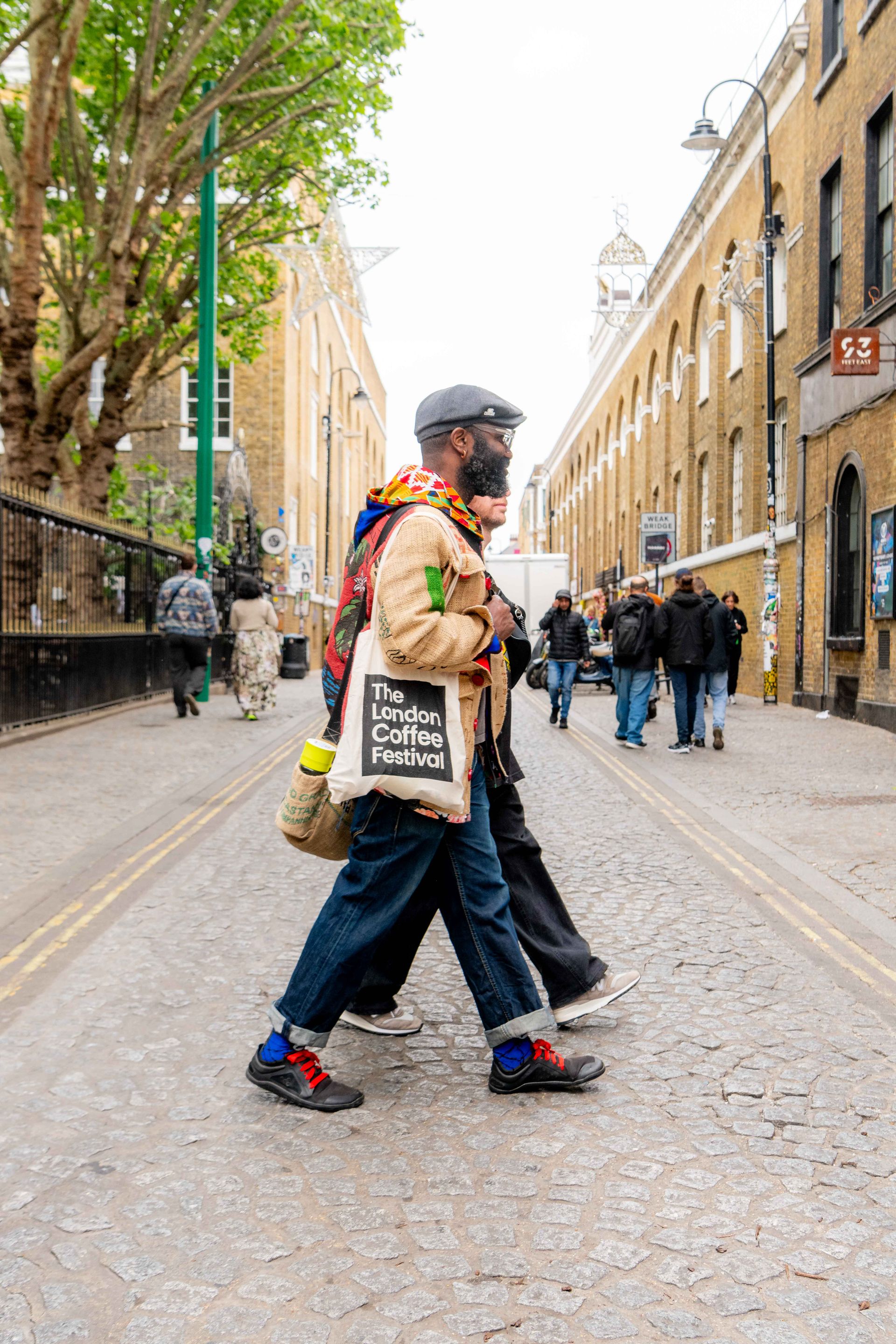 Person walking in London with LCF tote bag