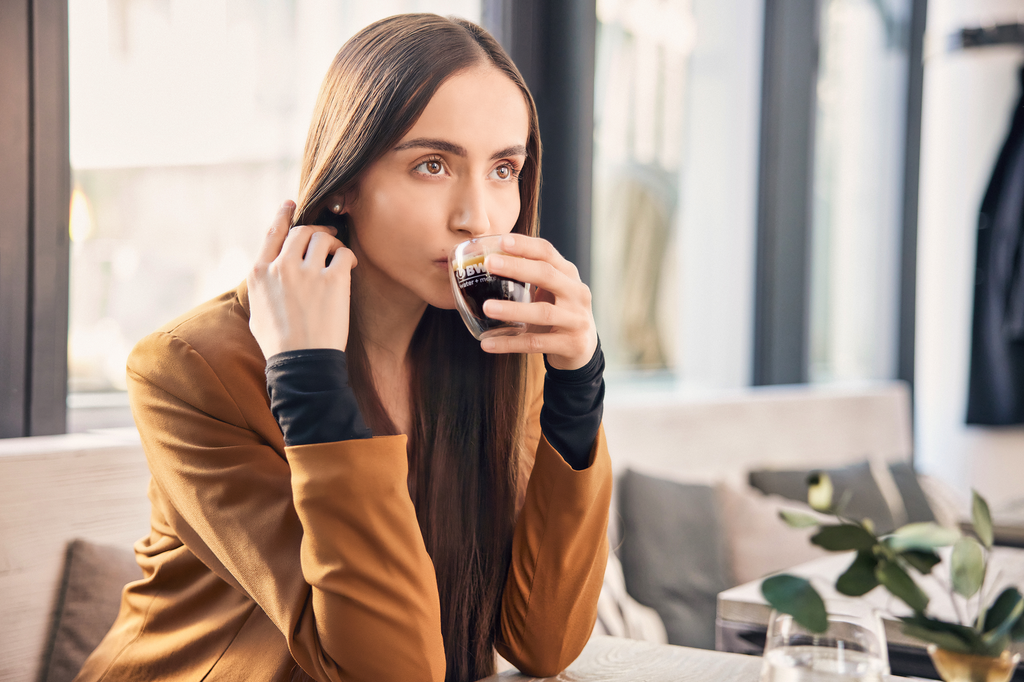 Woman drinking espresso