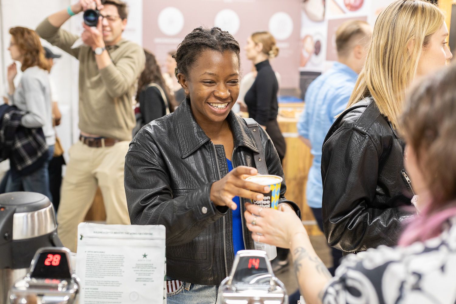 A smiling visitor in the crowd at The London Coffee Festival