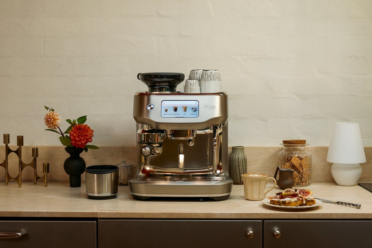 Person holding coffee infront of Sage coffee machine